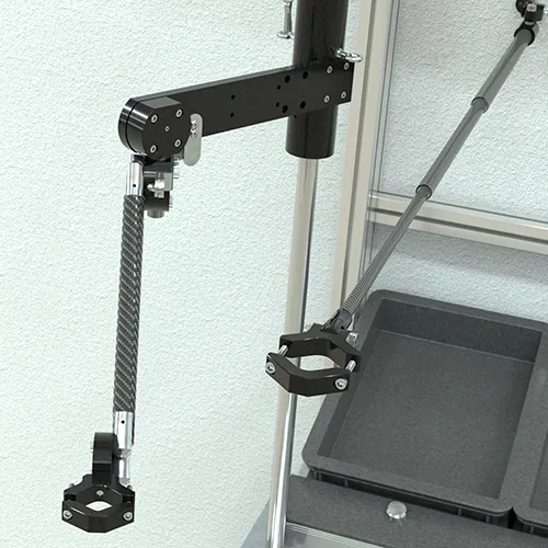 Two carbon reaction arms from the TA line, mounted at a workstation for assembly and screwdriving.